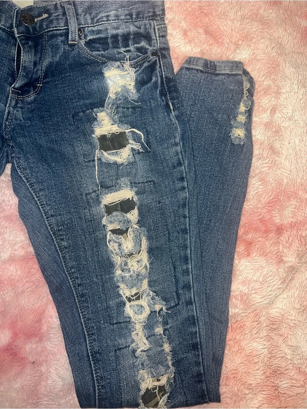 Distressed jeans with camo print